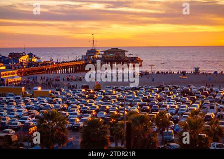 The beachfront parking lot in Santa Monica, california during sunset. Picture taken from the bluffs with the santa monica pier in the background. Stock Photo