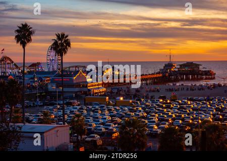 The beachfront parking lot in Santa Monica, california during sunset. Picture taken from the bluffs with the santa monica pier in the background. Stock Photo