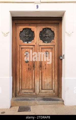 Ronda, Malaga, Spain- October 21, 2023:Beautiful old wooden door with wrought iron details and vintage door knocker in Ronda, Malaga Stock Photo