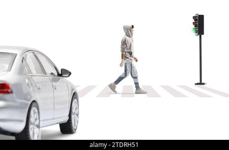 Full length shot of a tall guy wearing a gray hoodie and crossing a street isolated on white background Stock Photo