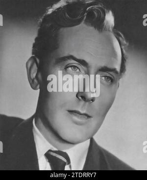 Michael Wilding starred in the 1948 film 'Spring in Park Lane.' In this popular British romantic comedy, Wilding plays the charming and mysterious footman Richard, who finds himself in a romantic entanglement with his employer's niece, Judy, portrayed by Anna Neagle. His performance in 'Spring in Park Lane' not only showcases his debonair screen presence but also contributed to the film becoming one of the highest-grossing British releases of its time. Stock Photo