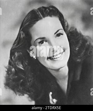 Patricia Roc (born June 7, 1915 - died December 30, 2003) was celebrated for her role in 'Millions Like Us' (1943). This British wartime drama focuses on the lives of women entering the workforce during World War II, highlighting their struggles and camaraderie. Roc's performance as Celia Crowson resonates deeply, capturing the essence of determination and resilience during a tumultuous era. Stock Photo