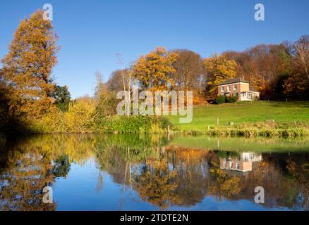 Beautiful country house in Rozendaal located on a hill above a lake and surrounded by trees decorated in autumn colors Stock Photo