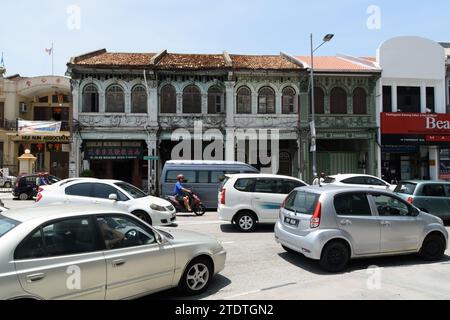 81 Jalan Magazine, George Town, Penang, Malaysia - March 12th 2018: Traffic passing shops and apartments. Stock Photo