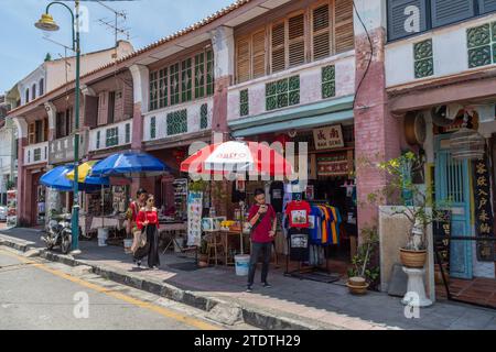 Lebuh Armenian, George Town, Penang, Malaysia - March 12th 2018: Shoppers passing shops in the street. Stock Photo