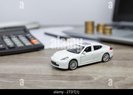 Car and finance. Purchase and insurance. Calculator for counting on the desktop. Stock Photo