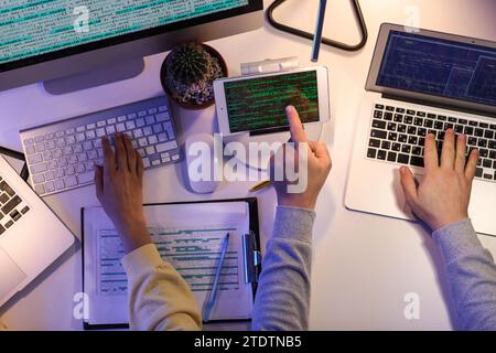 Programmers working in office at night, top view Stock Photo