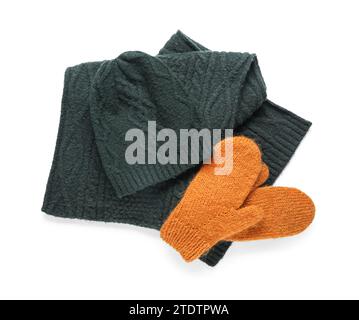 Pair of orange knitted mittens with warm hat and scarf on white background Stock Photo