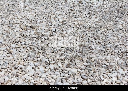 Gravel of large fractions Crushed stone building aggregate stone structure. Crushed Stone close-up Lies on ground. Breakstone. Granite gravel construc Stock Photo