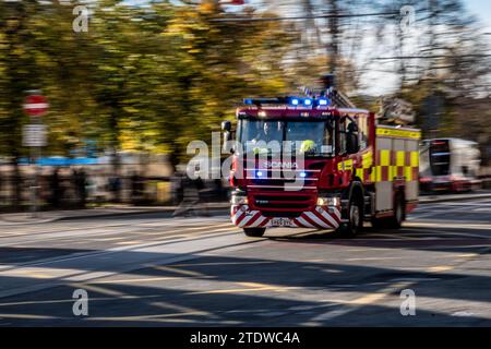 Motion Photo - Blue Light Scottish Fire & Rescue Scania P280 Fire Engine On Princes Street, Edinburgh, Scotland, UK Responding To An Emergency Stock Photo