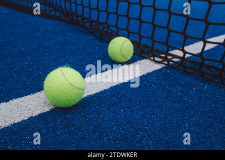 two balls in a blue paddle tennis court Stock Photo