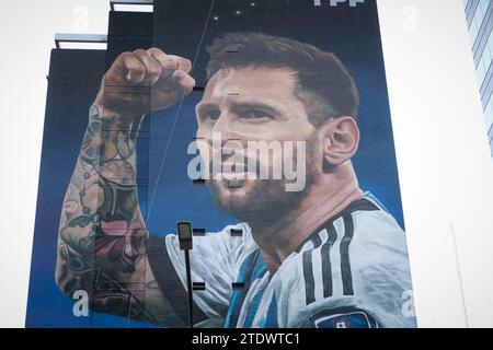 A mural of Lionel Messi is seen on the first anniversary of obtaining the Qatar 2022 World Cup champion trophy. A giant mural of Messi on Avenida 9 de Julio. The mural is a tribute to the world champion Lionel Messi on obtaining the world champion trophy in the 2022 World Cup in Qatar, made by the muralist Martín Ron, it is located in the center of the City of Buenos Aires. Stock Photo