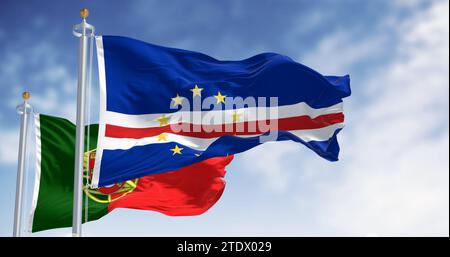 Cape Verde national flag waving iwaving with the portuguese flag on a clear day. Cape Verde and Portugal share a historical and cultural connection. 3 Stock Photo