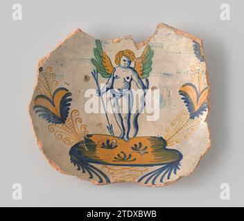 Fragment in the form of a bottom of a dish, painted with a putto between two aigrets, anonymous, c. 1600 - c. 1650 Fragment in the form of a bottom of a dish, painted in blue, orange and green with a putto (Amor with bow and arrow) on a ground between two aigrets. North Holland earthenware Fragment in the form of a bottom of a dish, painted in blue, orange and green with a putto (Amor with bow and arrow) on a ground between two aigrets. North Holland earthenware Stock Photo