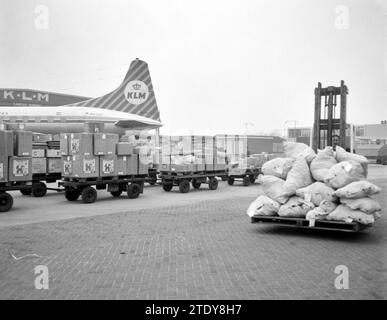 Cargo being shipped during the Christmas rush at Schiphol, KLM airplane in background ca. December 20, 1962 Stock Photo