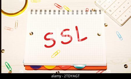 SSL word on a checkered notebook on a light table next to a magnifying glass, paper clips, stationery buttons, a calculator Stock Photo