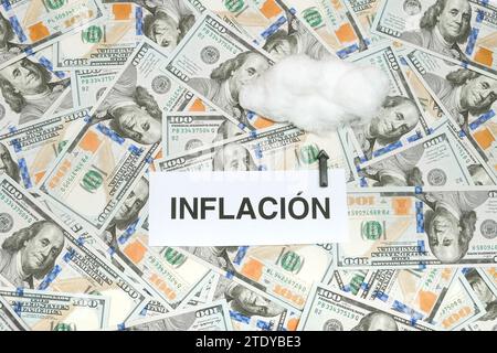 Spanish Word 'Inflación' Written On A Paper And An Arrow Pointing To A Cloud meaning Inflation Skyrocketed As A Result Of The Economic Crisis Stock Photo