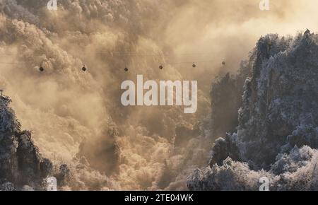 Beijing, China. 19th Dec, 2023. This aerial photo taken on Dec. 19, 2023 shows mountains amid mist after a snowfall in a national forest park of Zhangjiajie, central China's Hunan Province. Credit: Wu Yongbing/Xinhua/Alamy Live News Stock Photo