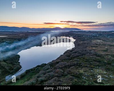 Smoke over Lough Fad due to traditionally burning of waste in rural Ireland - County Donegal. Stock Photo
