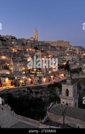 Matera, Italy - 26 November, 2023: view of the old town of Matera after sunset with the lights coming on Stock Photo