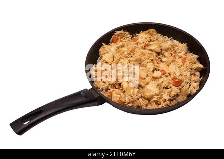 Tasty pilaf with chicken in a frying pan. Isolated on a white background. Stock Photo