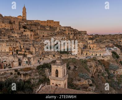 Matera, Italy - 26 November, 2023: view of the old town of Matera at sunset with the lights coming on Stock Photo