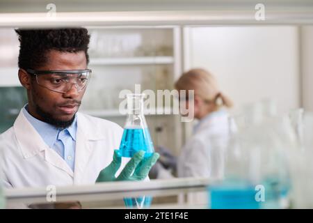 Male Medical Laboratory Researcher Holding Flask Stock Photo