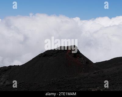 Eruptive cone of piton de la Fournaise volcano on top of the clouds, Reunion island, France. small crater in La Réunion Stock Photo