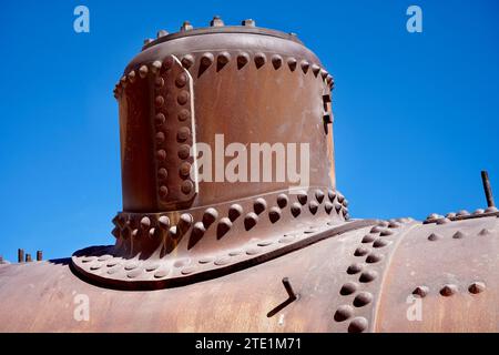Rusty Ironwork on an abandoned steam train under a blue sky. Stock Photo