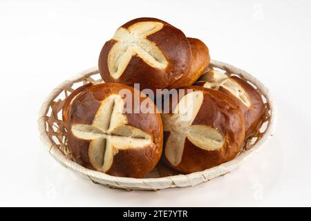 German Pretzel Rolls in Basket on White Background - Traditional Breakfast Bakery Snack Stock Photo