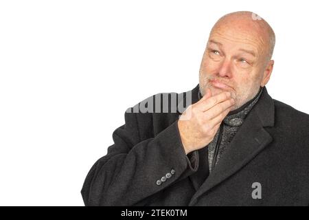 Winter Contemplation: Mature White Male in Dark Coat Looking Up Outdoors Stock Photo
