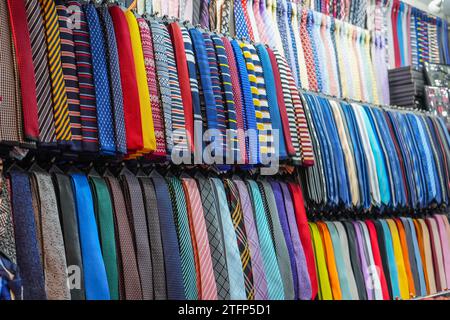 Many different ties of multi colors on display at the exhibition showcase. Large assortment of items for customers to choose from. Stock Photo