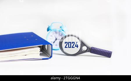 Calendar Of 2024 And Clock On A White Background Happy New Year 2024   Magnifying Glass With The Word 2024 On A White Table With A Clock And A Blue Folder New Year Planning Concept Focused On 2024 Word Business Concept 2tgggn4 