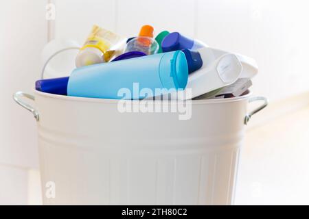 Plastic waste in a white garbage can in a throwaway society causing microplastics Stock Photo