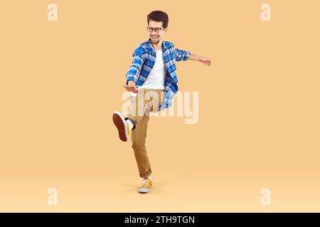 Full length body size photo of smiling man dancing at party. Stock Photo