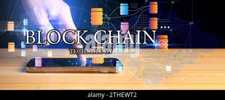 Blockchain technology and network concept. Businessman holding text blockchain in hand with icons network connection on blue security and digital conn Stock Photo