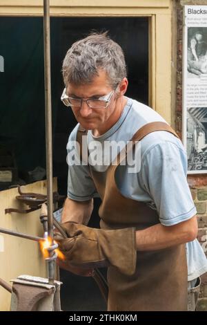 England, West Sussex, Arundel, Amberley Museum and Heritage Centre, Blacksmith at Work Welding Stock Photo