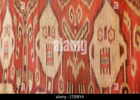 Anthropomorphic figures. Detail of a warp ikat decorated Pua Kumbu, an Iban, Dayak,  ceremonial textile from Borneo. The Iban live in both Sarawak, Malaysia and Kalimantan, Indonesia. Property Released. Stock Photo