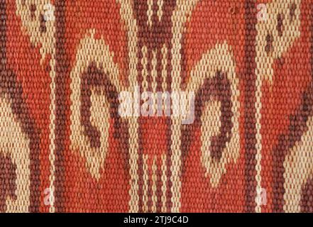 Detail of  warp ikat decorated Pua Kumbu with motifs representing foliage fronds. An Iban, Dayak,  ceremonial textile from Borneo. The Iban live in both Sarawak, Malaysia and Kalimantan, Indonesia. Property Released. Stock Photo