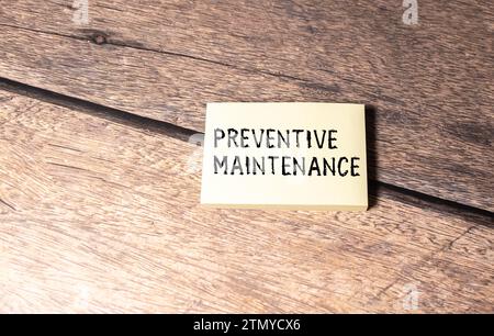 Preventive Maintenance text written on a notebook with pencils. Stock Photo