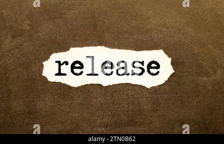 Press Release a lot of stickers are scattered on a wooden background with text on a notepad Stock Photo