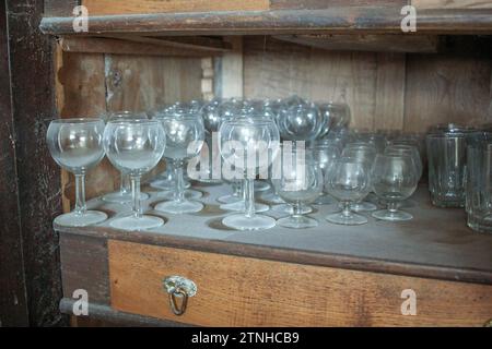 Hidden Treasures: Discovering Antique Glasses in the Old Cupboard Stock Photo