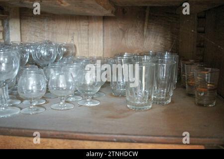 Hidden Treasures: Discovering Antique Glasses in the Old Cupboard Stock Photo