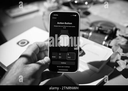 London, United Kingdom - Sep 23, 2022: An unboxing image in black and white showcases the setup of the new Apple iPhone 15 Pro, emphasizing the action Stock Photo