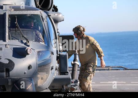 Airmen from the 305th Rescue Squadron, 943d Rescue Group, 920th Rescue Wing, land an HH-60G Pave Hawk Helicopter on the flight deck of Independence-variant littoral combat ship USS Cincinnati (LCS 20) to conduct a personnel recovery mission to demonstrate combat search and rescue operations at sea in support of Exercise Steel Knight 23.2, Dec. 5, 2023. Steel Knight is a three-phase exercise designed to train I Marine Expeditionary Force in the planning, deployment and command and control of a joint force against a peer or near-peer adversary combat force and enhance existing live-fire and mane Stock Photo