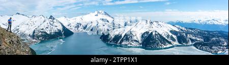 Spectator on Panorama Ridge with expansive view of Garibaldi Lake Stock Photo