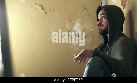 basemental drugs tobacco young drug dealer smoking in a basement and pass drug to a customer basemental drugs tobacco young drug dealer smoking in a basement and pass drug to a customer