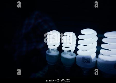 Four light bulbs glowing in the dark. Low Light photography. Stock Photo