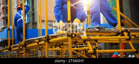 Construction workers working on scaffolding Stock Photo
