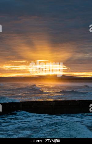 Winter sunrise over the windy sea at East Beach. Lossiemouth, Morayshire, Scotland. Stock Photo